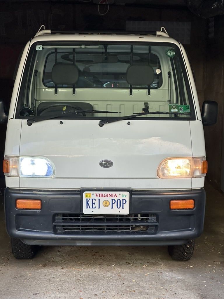 front of truck showing one LED light installed and one original bulb