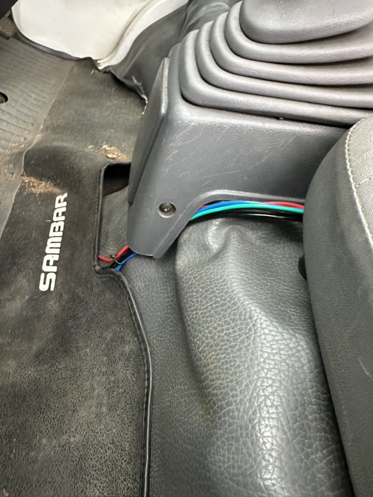 wires coming from under floormat