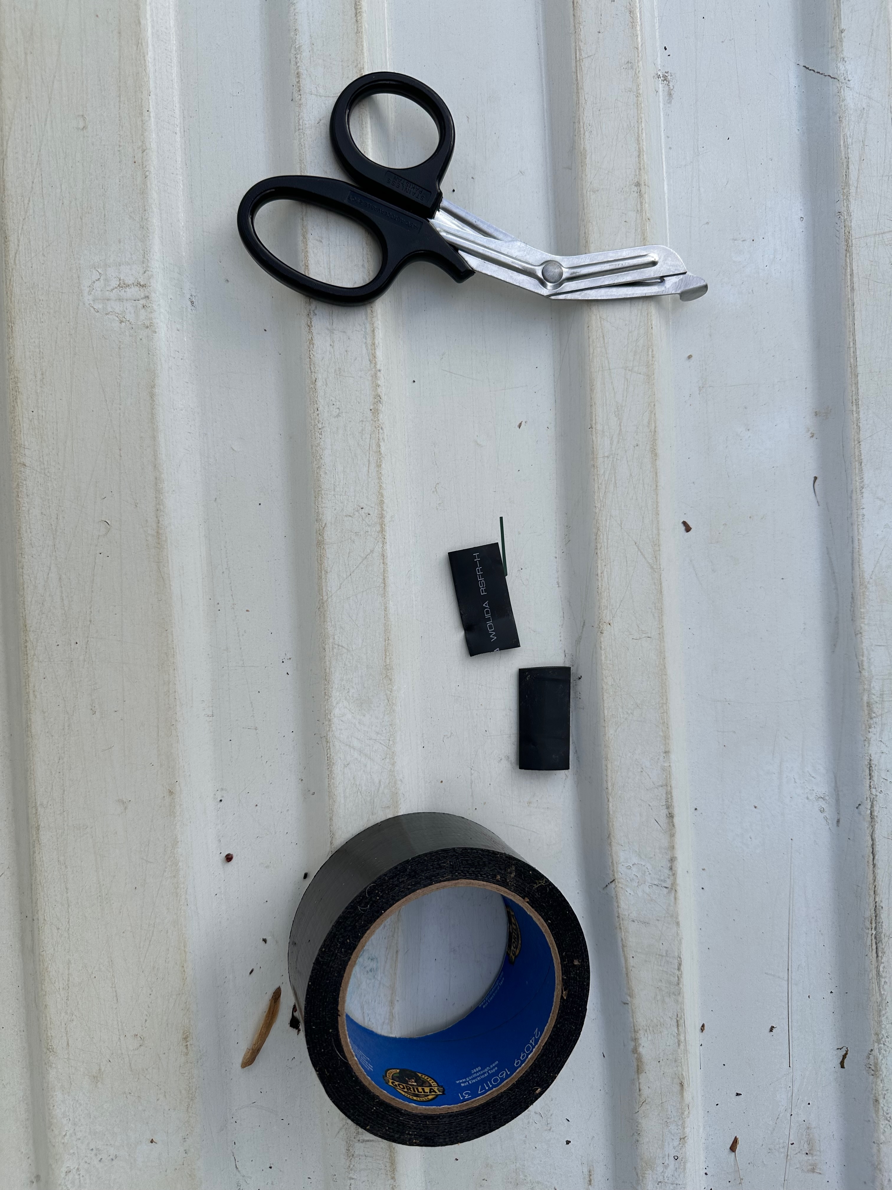 scissors, duct tape, and rubber wire insulator